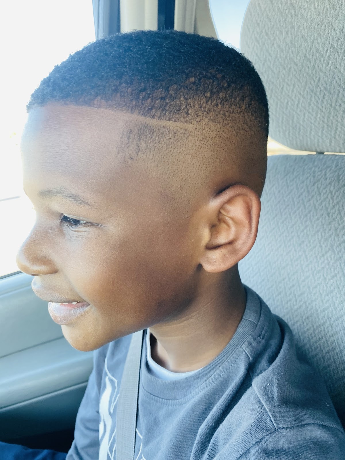 Hard part skin fade on one of our young regulars, checked in the car mirror on the ride home