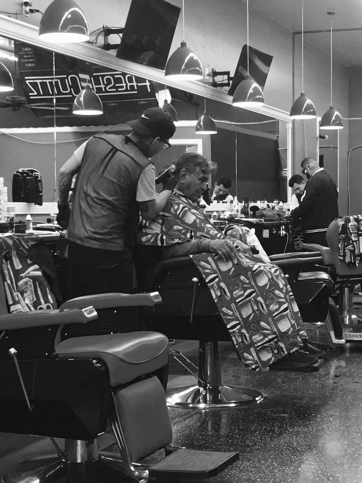 Black and white moment mid cut: one of our barbers detailing a longtime customer